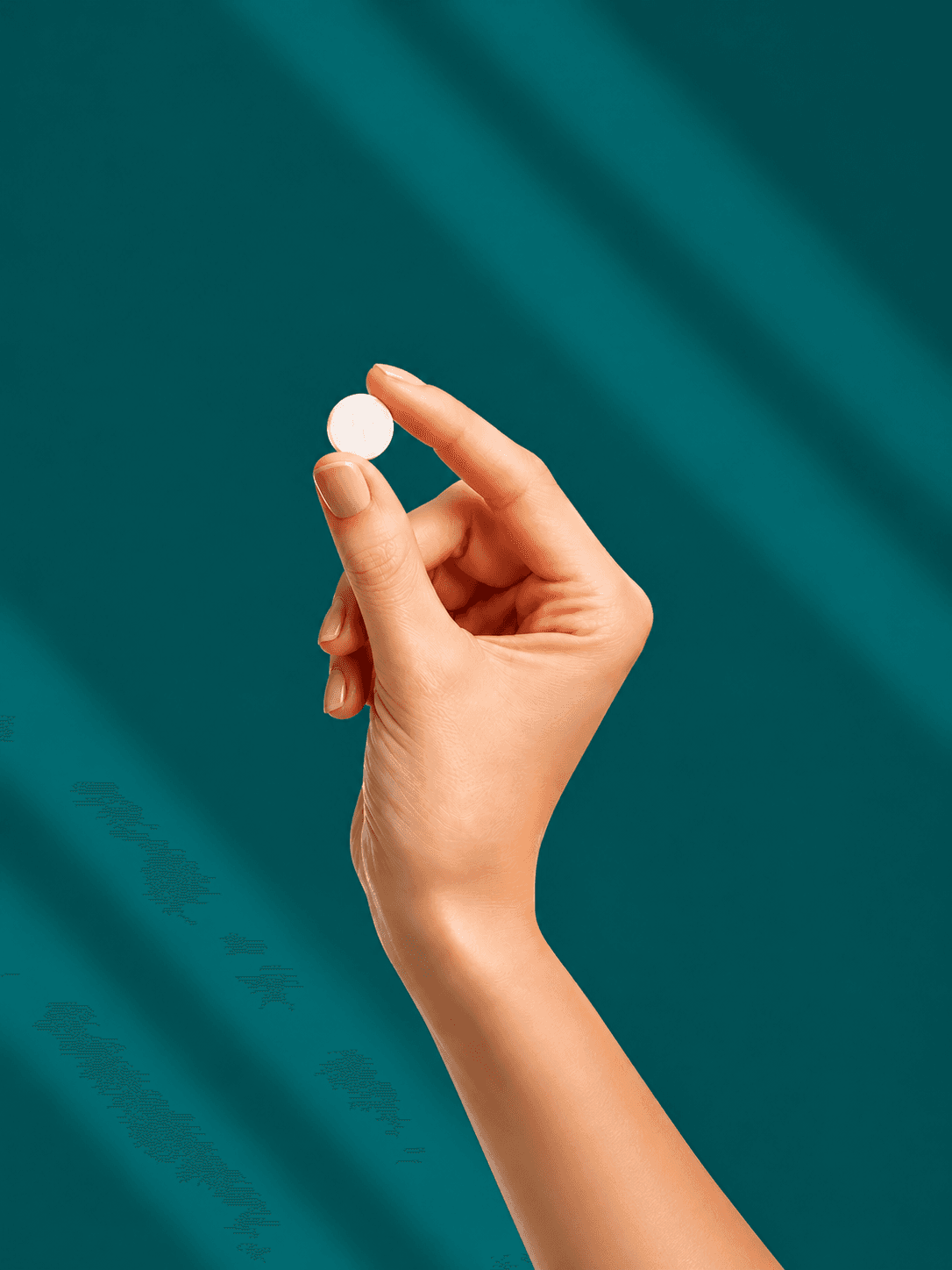 Hand holding a weight-loss tablet